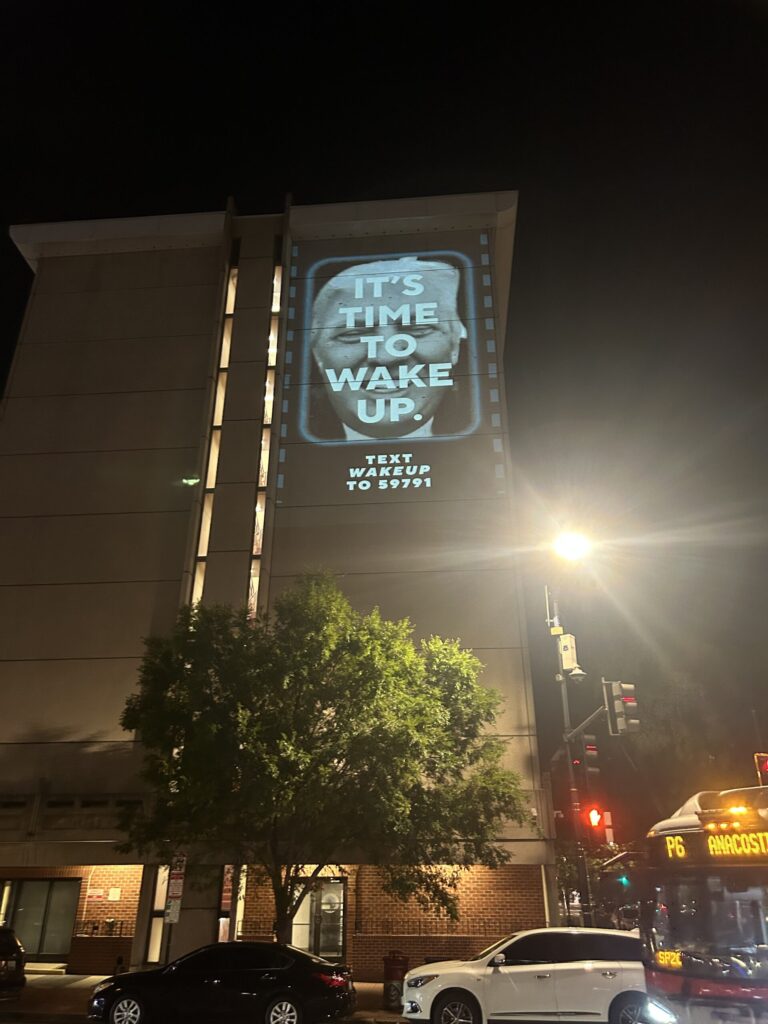 Building projection with "It's Time to Wake Up.