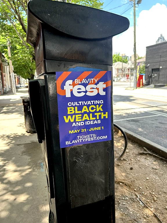 Poster on parking meter promoting Blavity Fest.