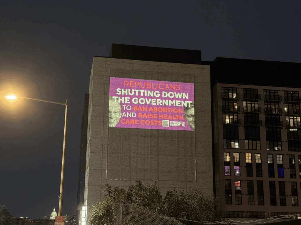 Projection on building criticizing government shutdown.