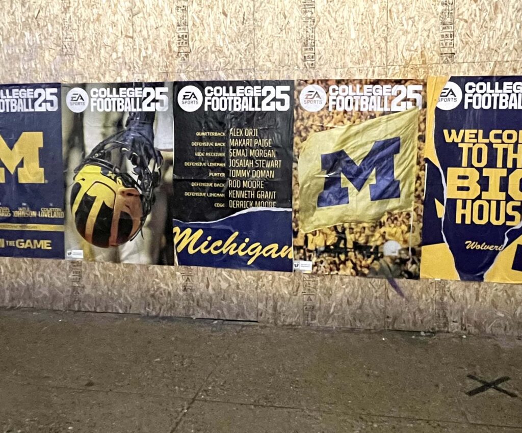 College football posters featuring Michigan themes.