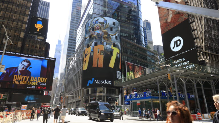 Times Square billboard featuring NASDAQ logo, vibrant advertisement for Microsoft, and surrounding urban traffic, capturing the dynamic atmosphere and high foot-traffic of the area.