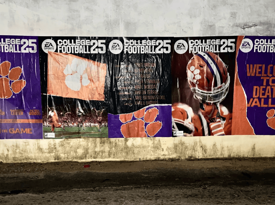 College football posters on a wall.