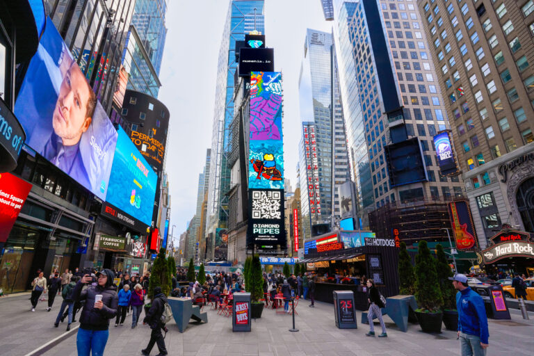 Times Square billboard featuring Diamond Peeps creative, vibrant animations, and QR code, surrounded by pedestrians and iconic urban architecture, highlighting the campaign's high visibility and engagement potential.