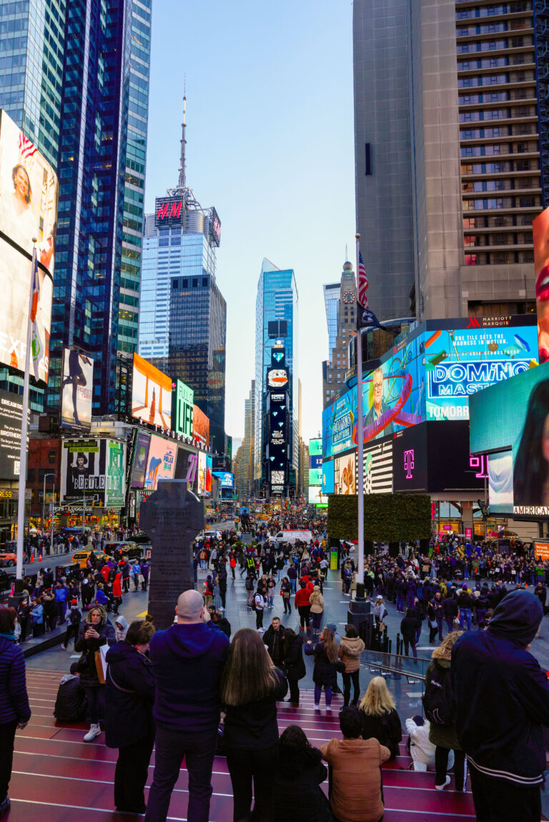 Crowd gathered in Times Square, showcasing vibrant billboards including the One Times Square display, highlighting the Diamond Peeps campaign's digital activation and audience engagement.
