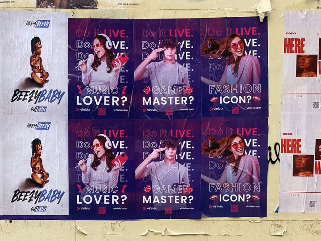 Posters featuring diverse individuals promoting interactive experiences, with text asking "Do it LIVE. Do you love music, gaming, or fashion?" in a vibrant street art context, representing guerrilla marketing in Wyoming.