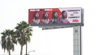 Billboard featuring three images of a man with long hair and beard, promoting the message "Community is the new currency," showcasing innovative advertising strategies relevant to American Guerrilla Marketing's out-of-home campaigns.