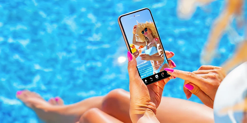 Person using smartphone to create TikTok content by a swimming pool, showcasing summer leisure and social media engagement.