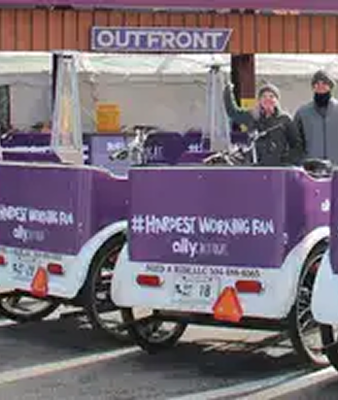 Pedicabs advertising services with purple branding and the hashtag #HAPPIESTWORKINGFUN, promoting innovative guerrilla marketing techniques in urban settings.