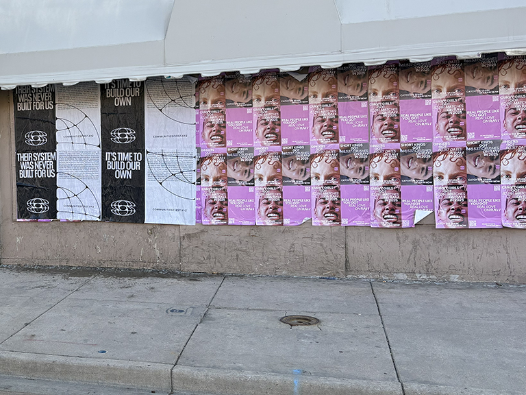 Billboard-style posters promoting community awareness and engagement, featuring diverse faces and messages about social justice and empowerment, displayed on a city wall.