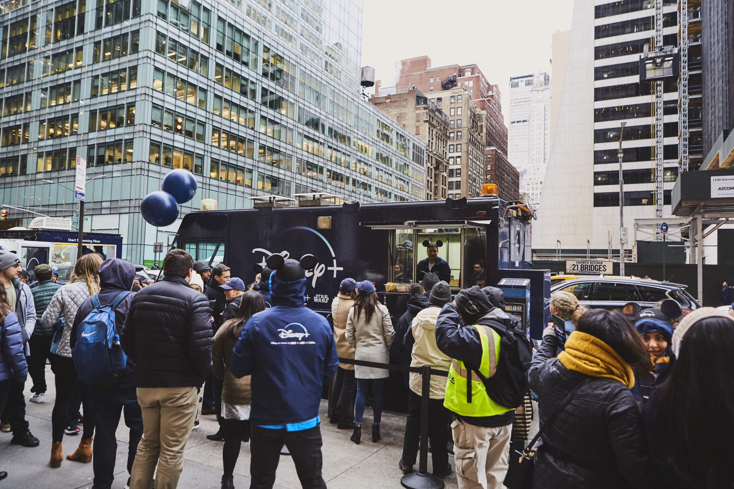 Crowd gathered around Disney+ activation food truck in Manhattan, New York, promoting brand engagement and awareness.