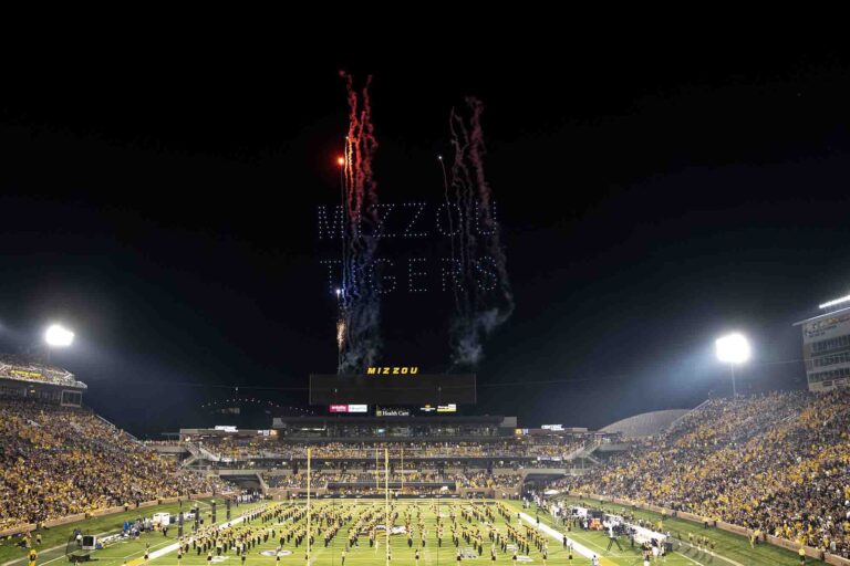 Drone light show displaying "MIZZOU TIGERS" above a packed stadium during halftime, with fireworks enhancing the visual spectacle, showcasing the University of Missouri's football opener event.