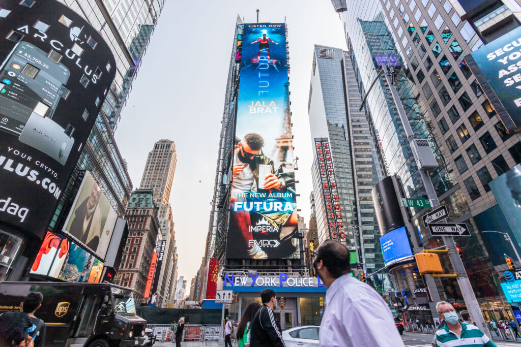 Jala Bratt billboard advertisement in Times Square, showcasing the new album "FUTURA," surrounded by urban architecture and pedestrians.