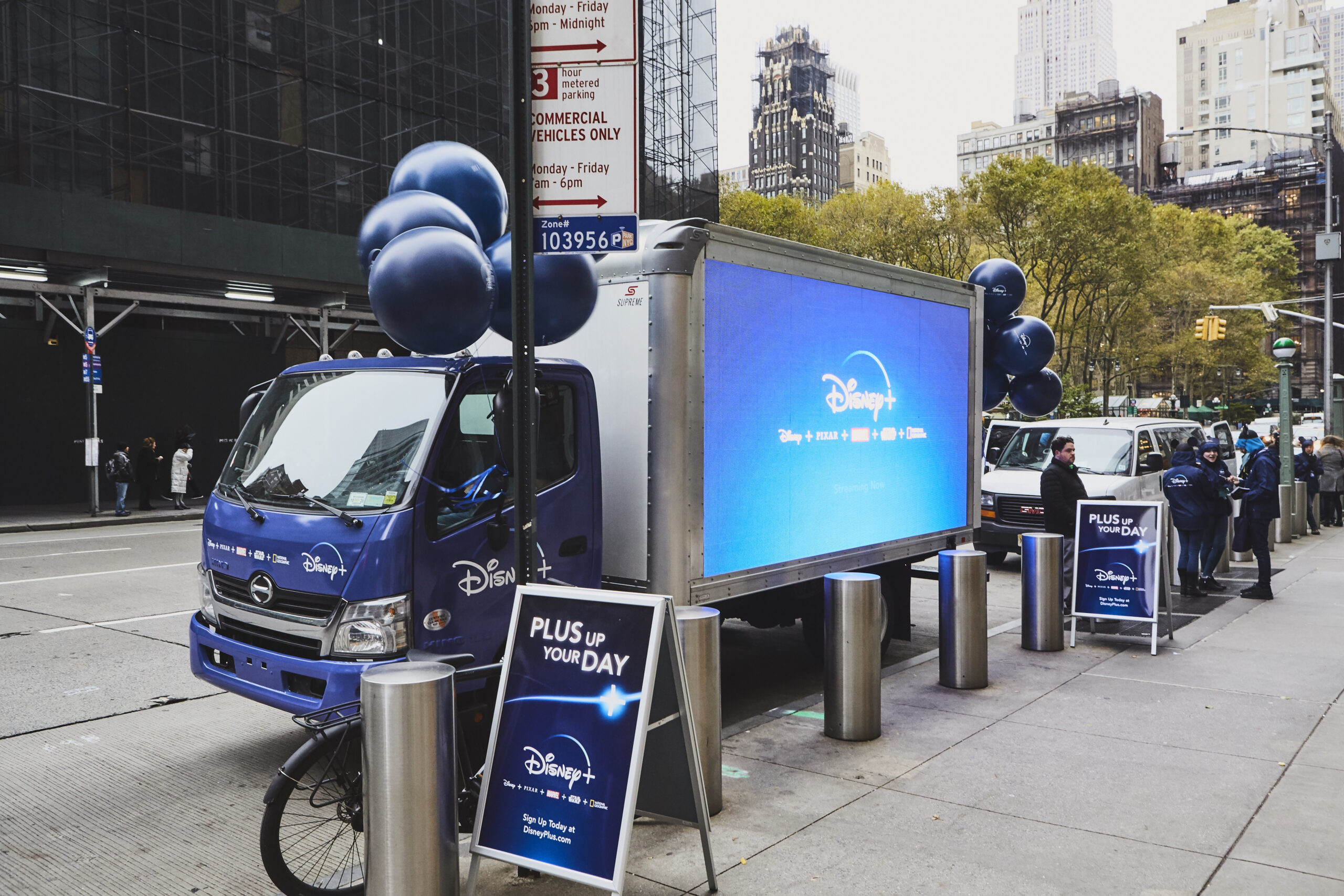 LED billboard truck advertising for Disney in New York City, featuring promotional signage and balloons, showcasing dynamic marketing solutions for brands.