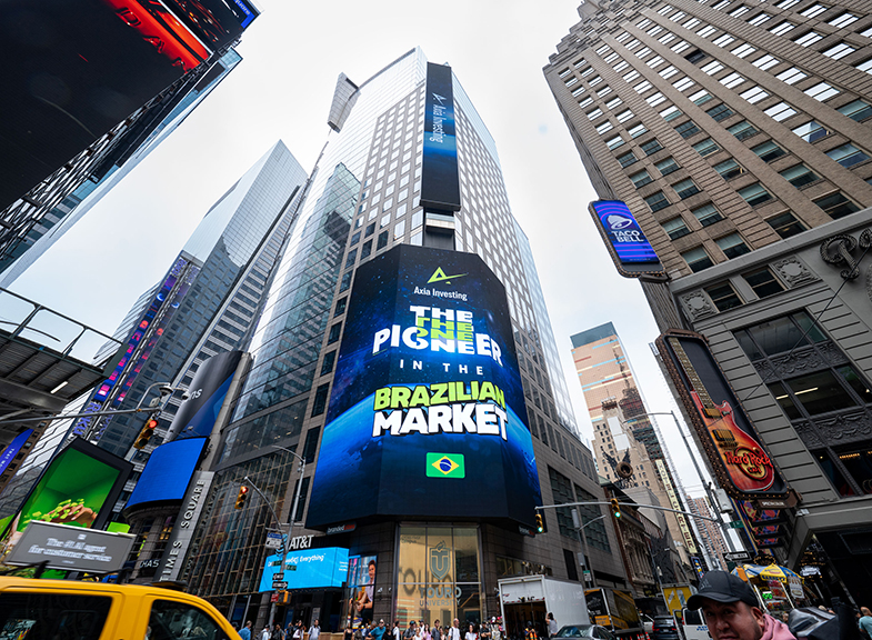 Billboard advertisement in Times Square promoting "Asia Investing: The Pioneer in the Brazilian Market," featuring vibrant graphics and the Brazilian flag.
