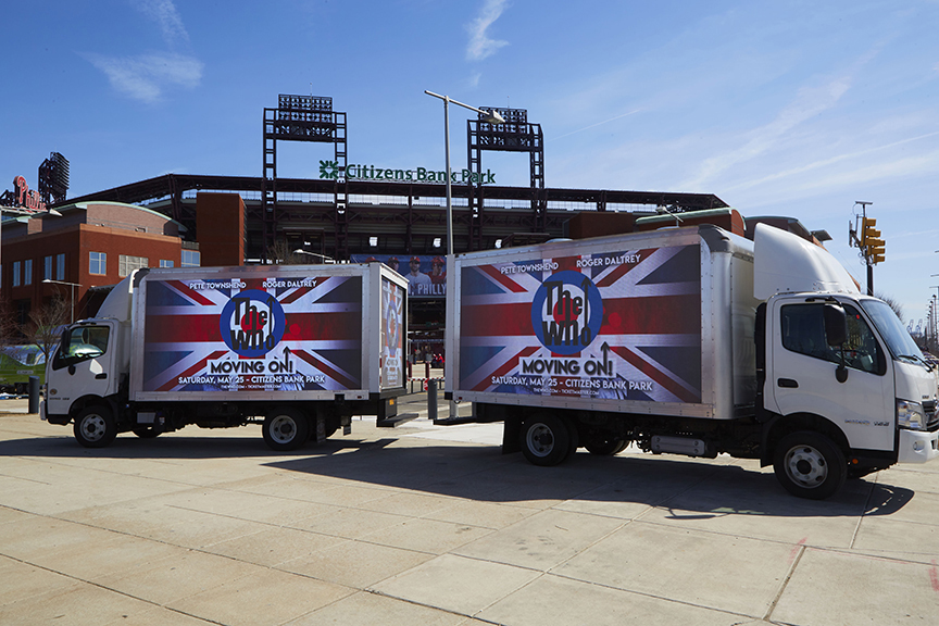 Billboard advertising trucks displaying promotional graphics for an event outside Citizens Bank Park, highlighting American Guerrilla Marketing's innovative outdoor advertising strategies.