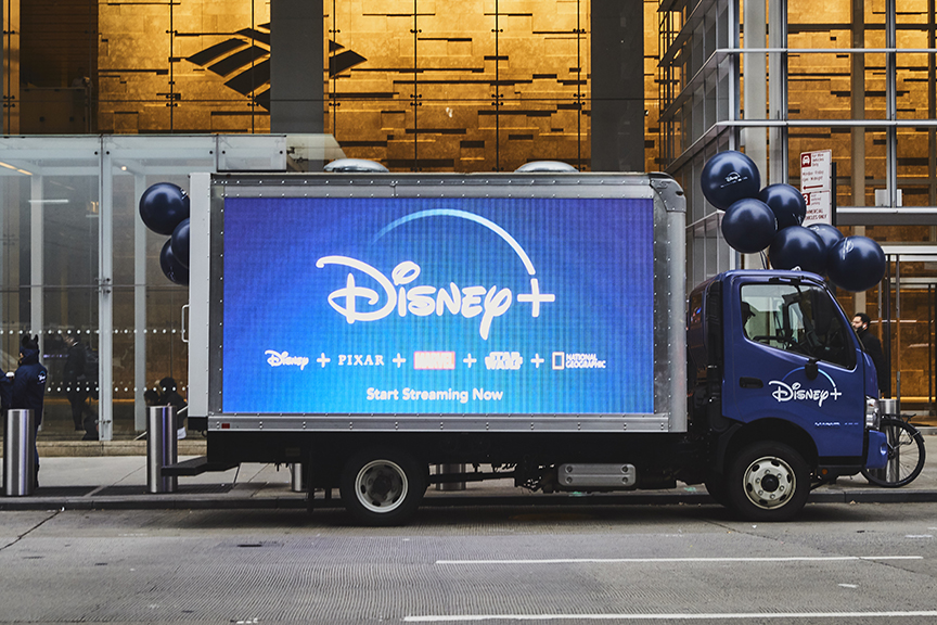14ft LED billboard truck featuring Disney+ advertisement with logos for Disney, Pixar, Star Wars, and National Geographic, promoting "Start Streaming Now" in Manhattan, New York.