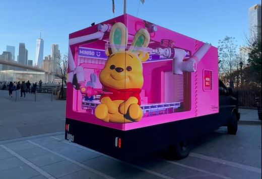 18ft LED billboard truck featuring MINISO &times; Disney collaboration, showcasing a colorful 3D character display, located in Times Square, New York.