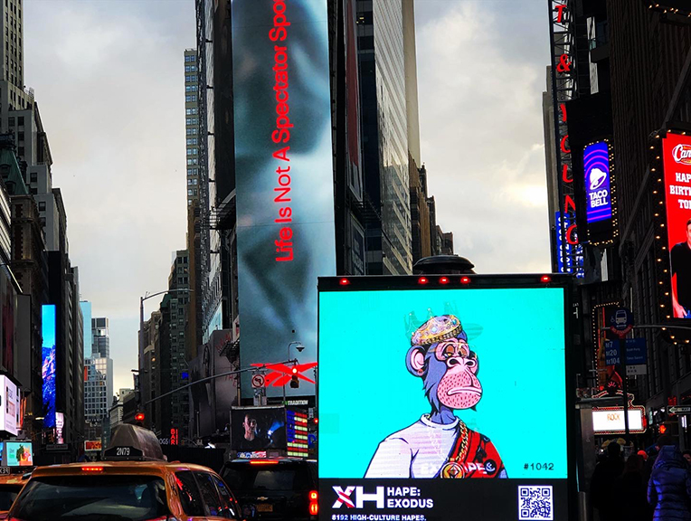 18ft LED billboard truck displaying HAPE &ndash; Exodus NFT campaign with vibrant monkey artwork in Times Square, New York, amidst bustling urban environment.
