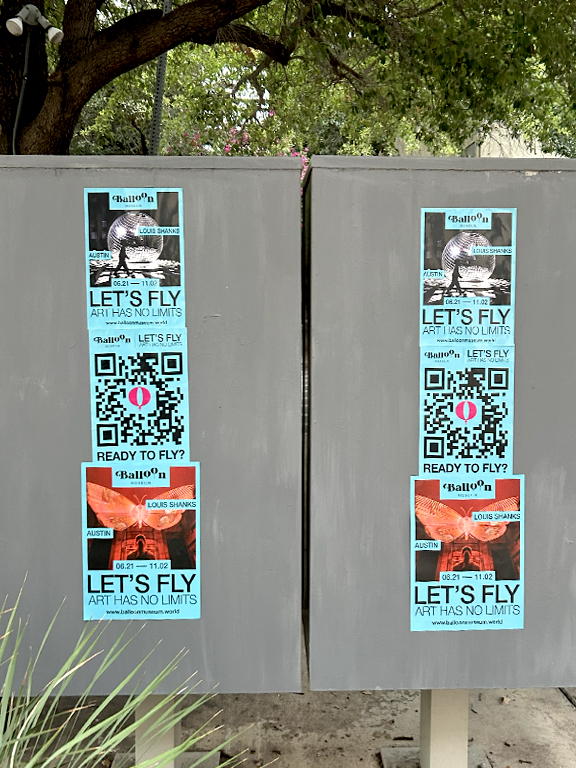 Balloon Museum promotional posters for "Let's Fly &ndash; Art Has No Limits" featuring QR codes and event details, displayed on utility boxes in Austin, Texas.