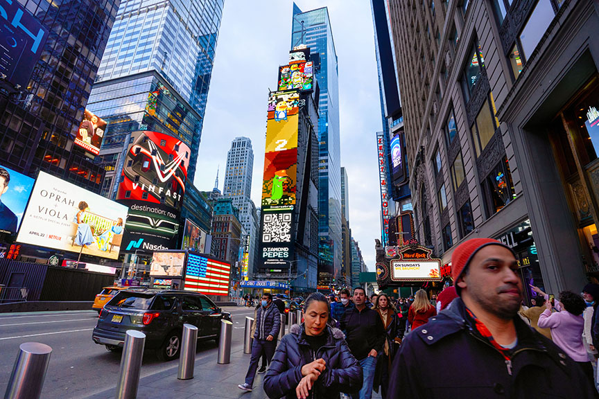 Times Square digital billboards showcasing advertisements, including Diamond Pepes and NASDAQ, with pedestrians walking in a bustling urban environment.