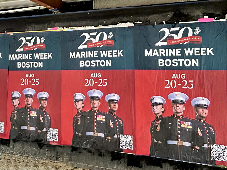 Wheatpaste posters promoting Marine Week Boston, featuring military personnel and event details, showcased in an urban setting.