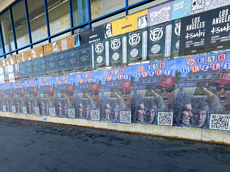 Wild Wheat Paste Posting Ad featuring multiple large posters with vibrant graphics and QR codes, promoting "Dear Kelly" in an urban setting, Los Angeles, California.