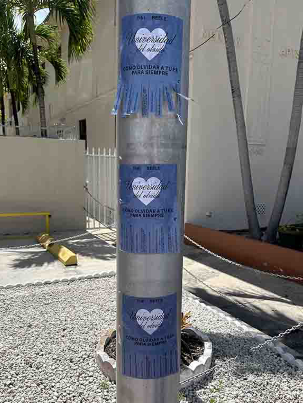 Posters on a street pole promoting a message about forgetting someone, designed for effective street-level engagement.