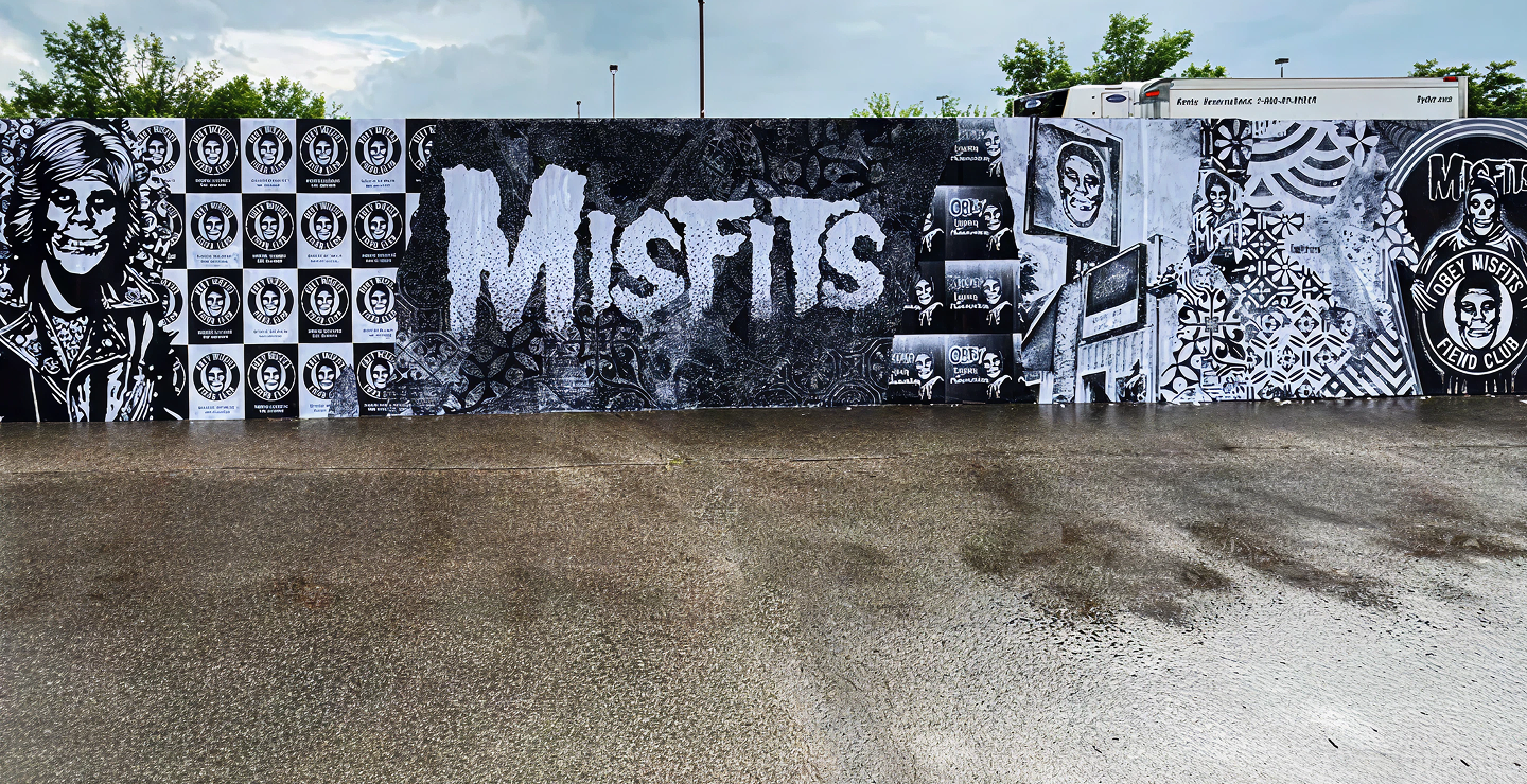 Mural featuring bold "MISFITS" text and various black-and-white illustrations, showcasing festival branding and artistic expression for music festival activations.