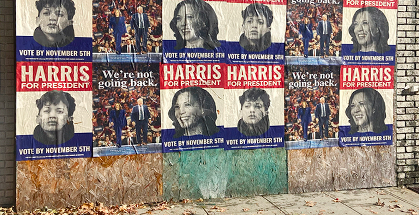 Posters promoting Harris for President, featuring diverse faces and the message "Vote by November 5th," emphasizing grassroots political engagement and visibility in urban settings.