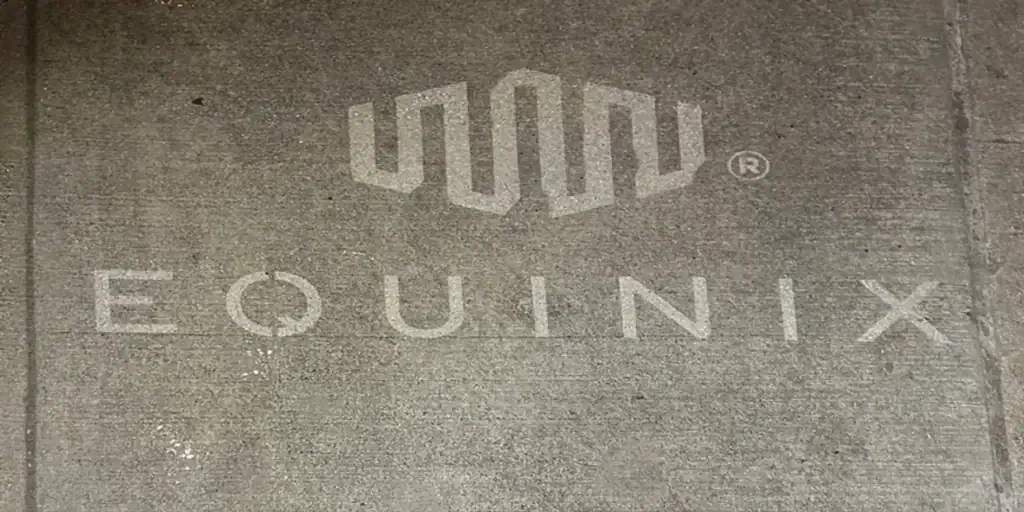 Sidewalk stencil featuring the Equinix logo, showcasing brand visibility in urban settings.