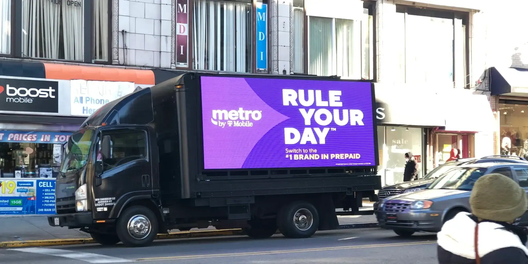 LED billboard truck displaying "RULE YOUR DAY" advertisement for Metro by T-Mobile, promoting mobile services in an urban setting.