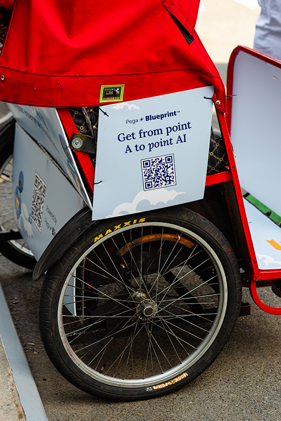Pedicab advertising featuring a QR code and branding for Pega Blueprint, emphasizing urban mobility and marketing solutions.
