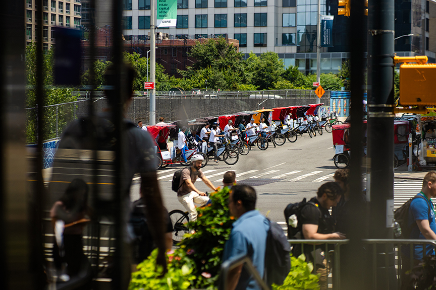 Pedicabs lined up on an urban street, showcasing advertising potential for mobile marketing campaigns by American Guerrilla Marketing.
