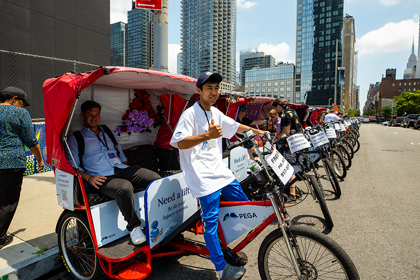 Pedicab drivers offering free rides in urban setting, showcasing advertising potential for brands, with visible promotional signage and cityscape backdrop.