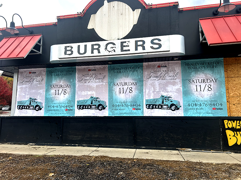 Burgers restaurant featuring promotional posters for Summer Walker's "Finally Get Rid of Your Ex's Stuff" event, with details on date and contact information, emphasizing guerrilla marketing strategies in urban settings.