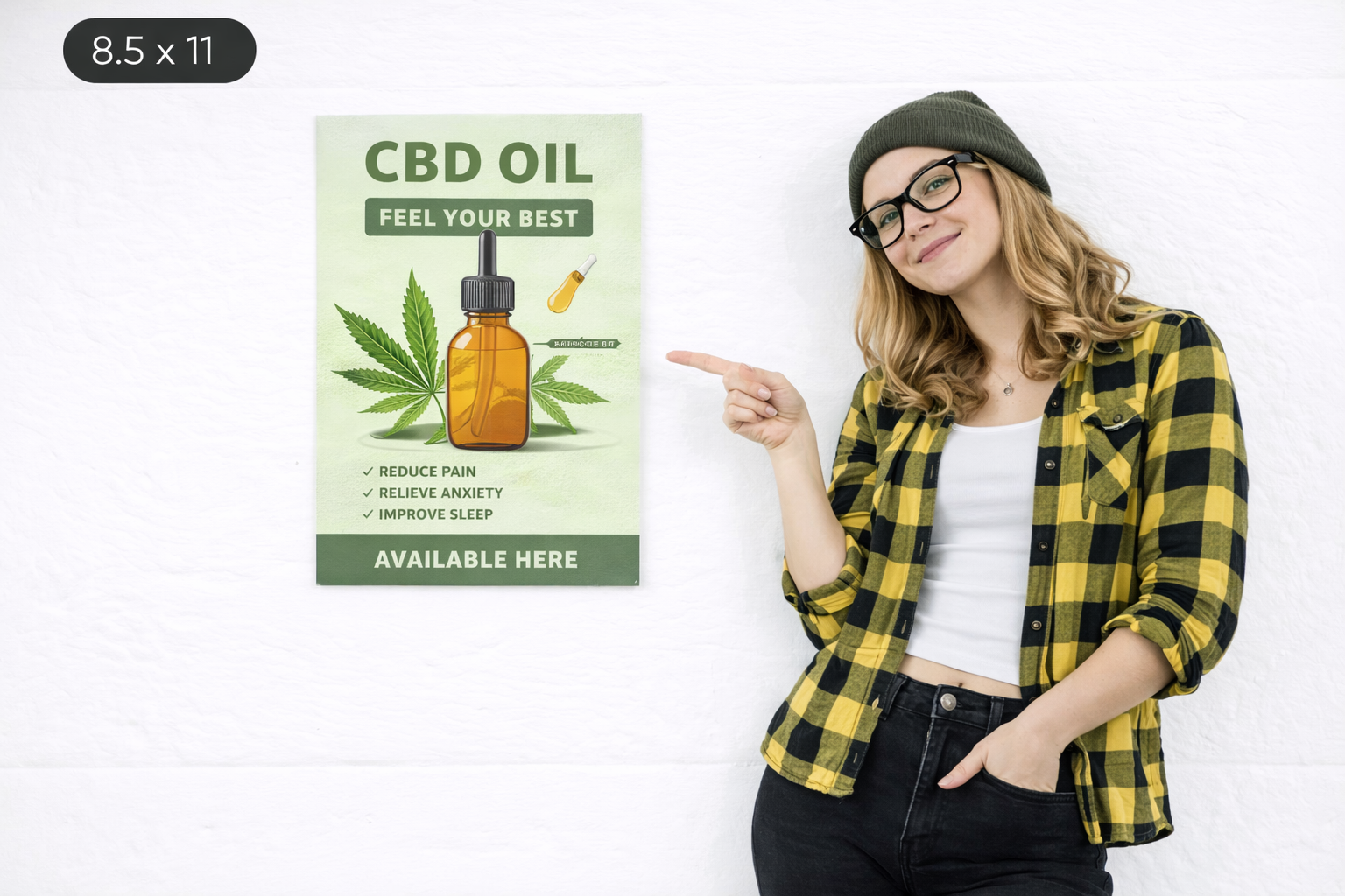 Woman in a black and yellow checkered shirt pointing at an 8.5 x 11-inch poster advertising CBD oil, highlighting benefits like reducing pain, relieving anxiety, and improving sleep.