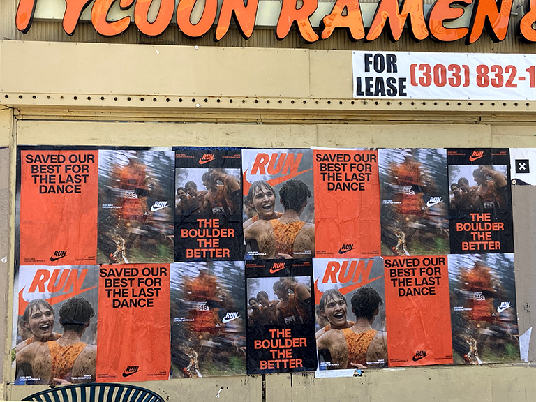 Posters featuring Nike advertisements with slogans "RUN," "SAVED OUR BEST FOR THE LAST DANCE," and "THE BOULDER THE BETTER," displayed on a wall near Tycoon Ramen in Milwaukee, showcasing guerrilla marketing strategies in a pedestrian-heavy area.